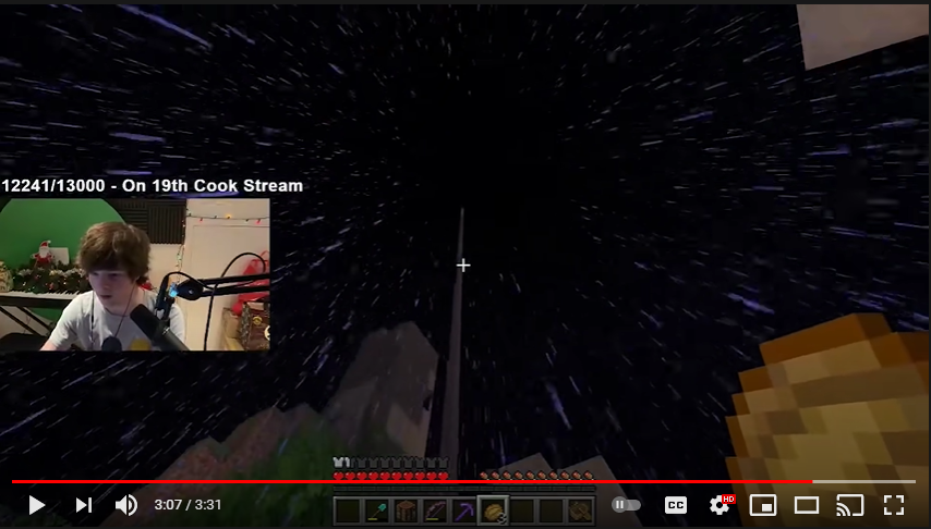 This is a screenshot from Tubbo's stream. He's looking up at a tall pillar in the sky. Raindrops are falling all around him. He holds a piece of bread in his hand. His facecam shows one of pure shock.